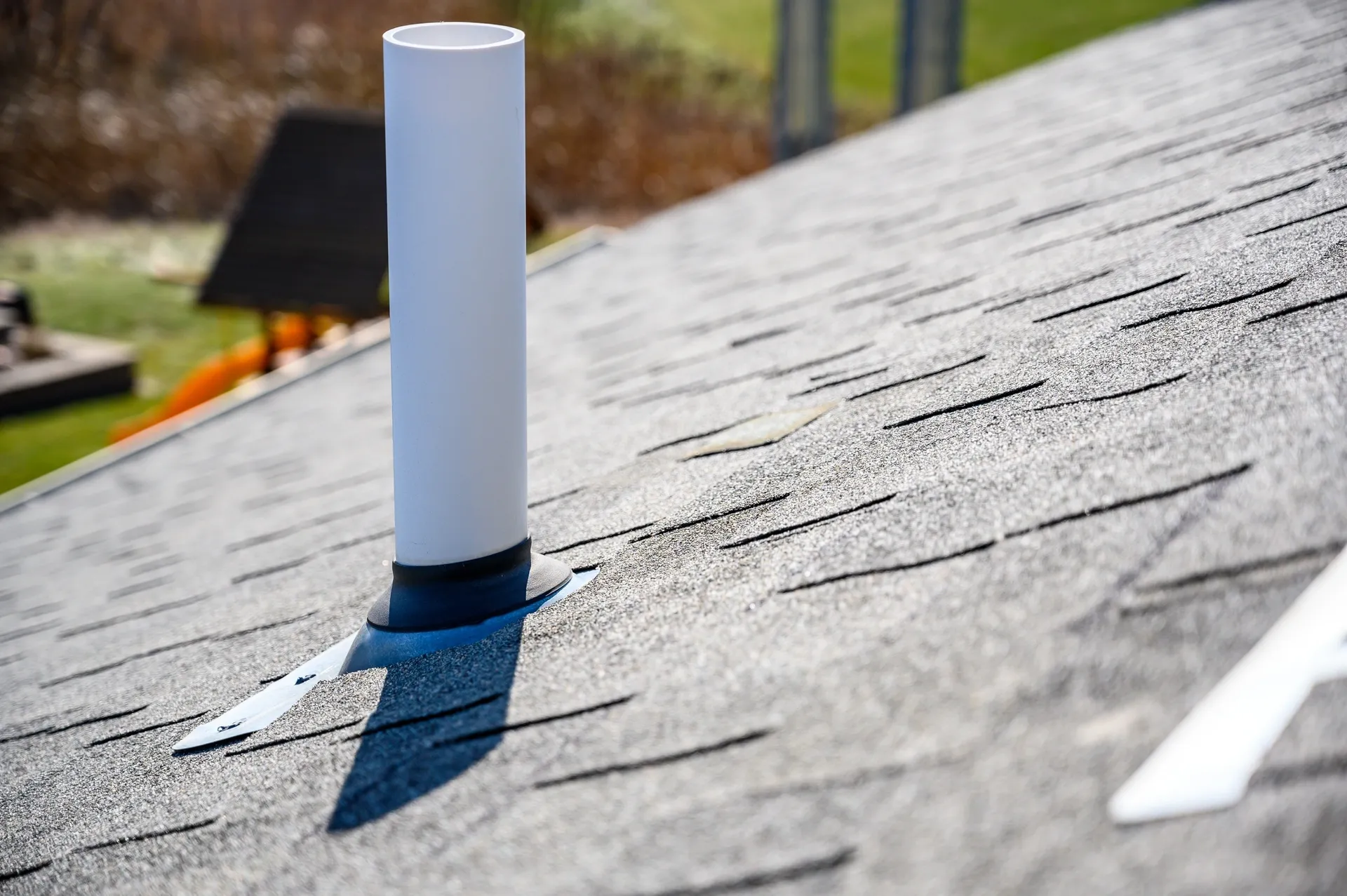 Radon vent pipe extending through a roof